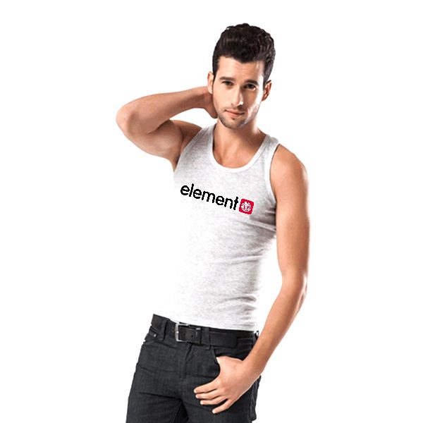 A young fit man poses in a light grey tank top and dark jeans against a plain white studio background.