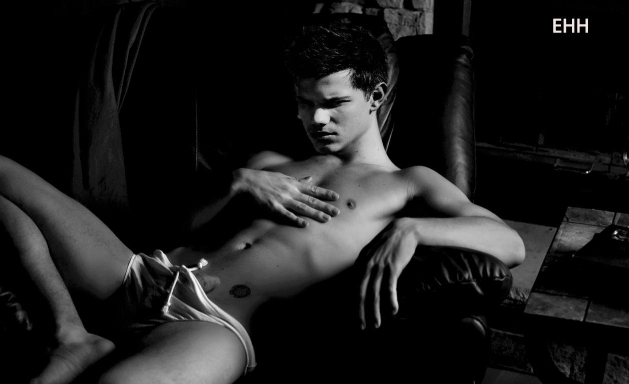 A young man with a smooth body reclines on a dark leather chair wearing underwear.