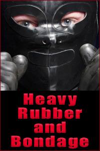 A close-up portrait of a person wearing a black rubber hood and gloves with red text reading Heavy Rubber and Bondage below.