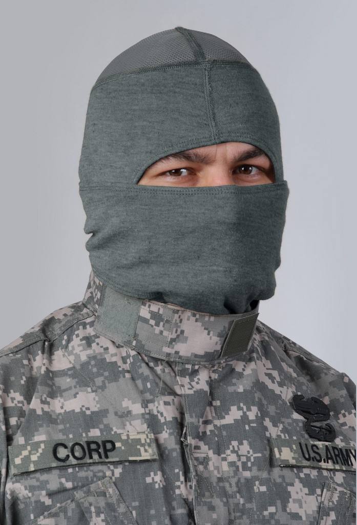 A man wearing a digital camouflage U.S. Army uniform and a grey fabric balaclava that masks his face.